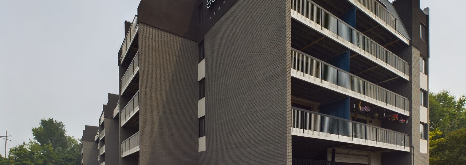 the parking lot of an apartment building with cars parked in front at The Edgewater