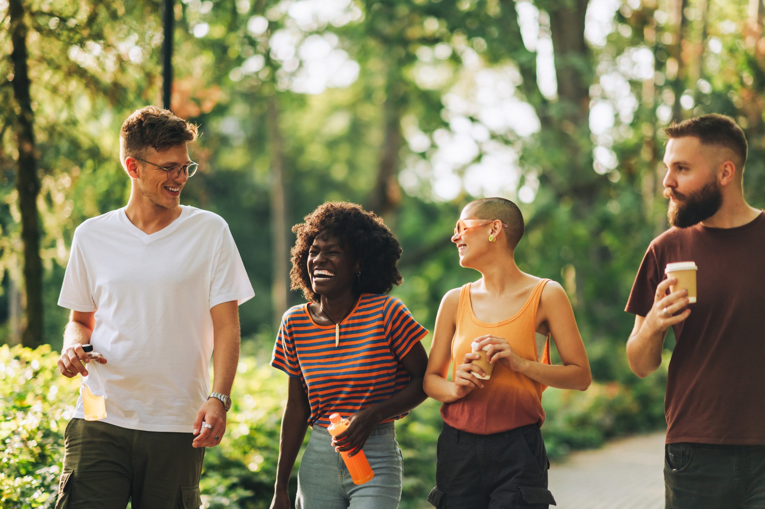 a number of people eating food in a park